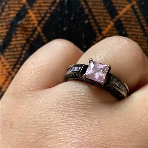 Black ring with pink diamond